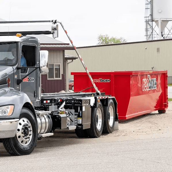 redbox+ dumpster next to delivery truck