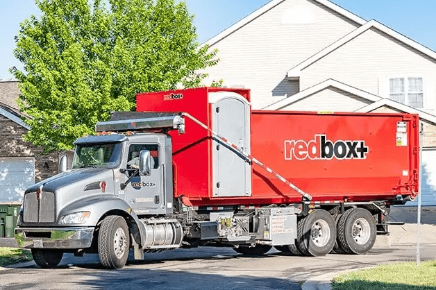 redbox+ dumpster being delivered to a residential home