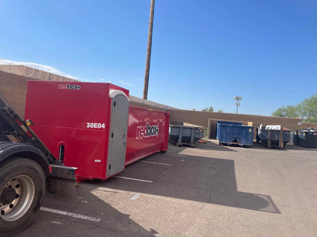 Elite roll-off dumpster rental red with two portable toilets