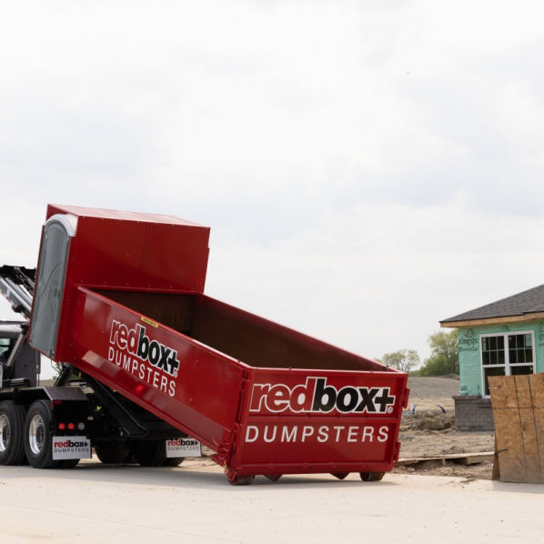 a roll-off dumpster being delivered