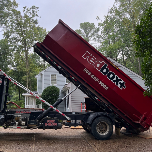 a roll-off dumpster is being delivered