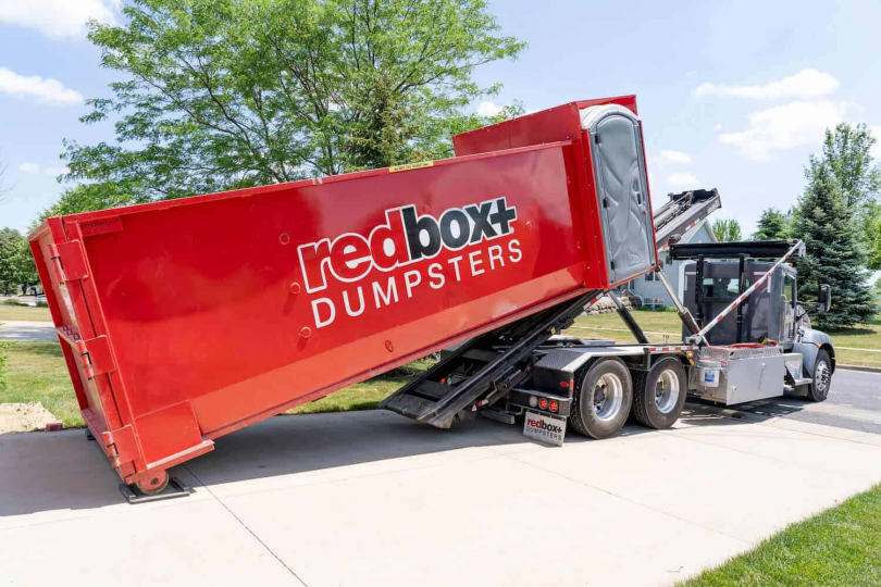 an elite dumpster being delivered