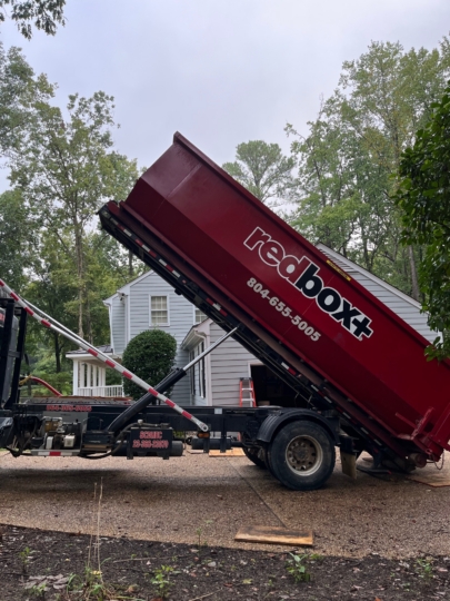 a roll-off dumpster is being delivered