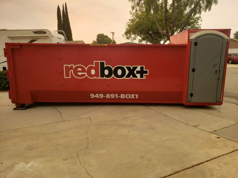 elite dumpster sitting in driveway riverside