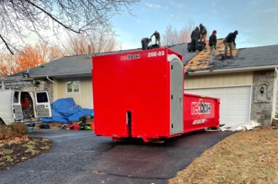 a roofing dumpster on a residential job location