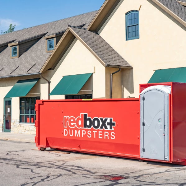 redbox+ Dumpster on street in front of commercial building