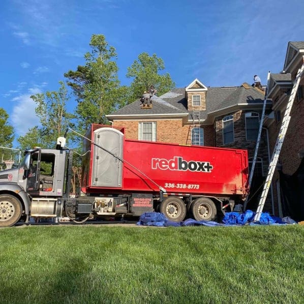 our elite dumpster is being delivered for a roofing contractor