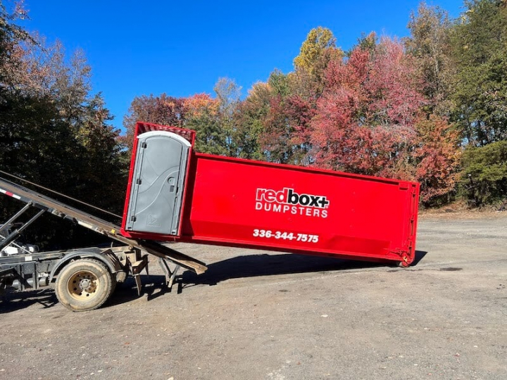 a roll-off dumpster is being delivered