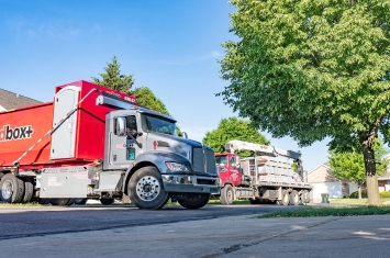 redbox+ Dumpster with construction truck in background