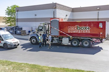 Commercial dumpster being transported to job site