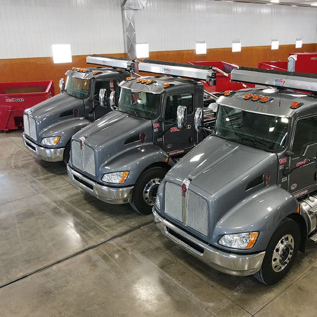 Rebox Plus trucks lined up in a garage