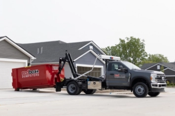 Roll-off dumpster being pulled by tow truck