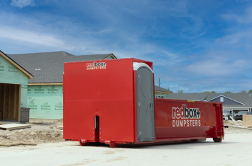 redbox+ dumpster in front of house being remodeled