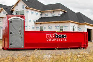 Roofing Dumpster Rental in front of Home that's Under Construction