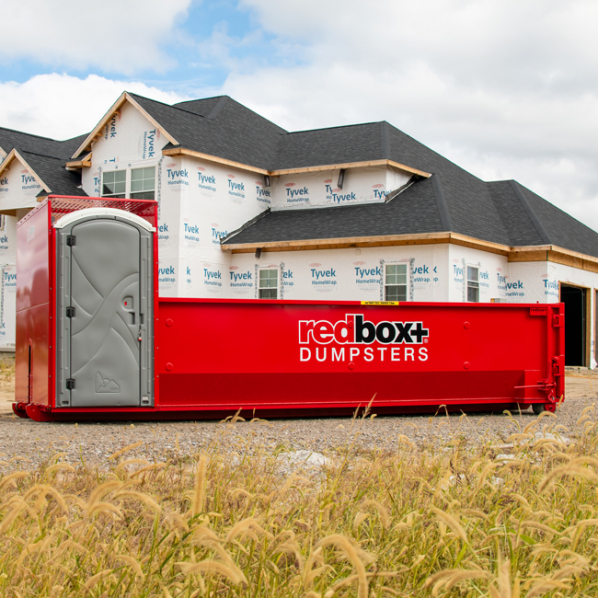 Roofing Dumpster Rental in front of Home that's Under Construction