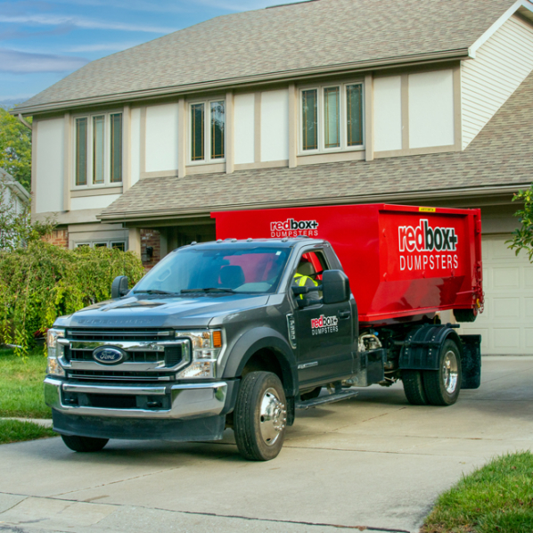 Yard Waste Roll-off Dumpster in driveway in front of a home